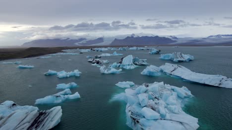 aerial of many icebergs pieces floating in jokulsarlon glacial lake, iceland