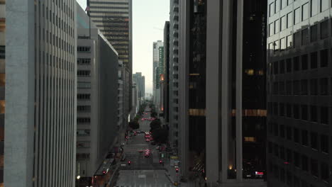 Endless-Skyscrapers-Urban-Canyon-of-City-Main-Street-Downtown-Area-in-Los-Angeles,-Scenic-Establishing-Shot-Dolly-in,-Aerial-Drone-perspective