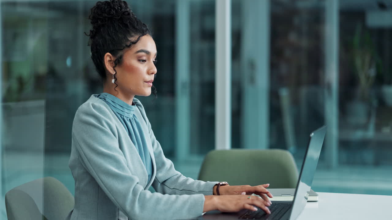 Professional businesswoman working on laptop in modern office