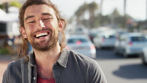 happy man, face and laughing on a city street