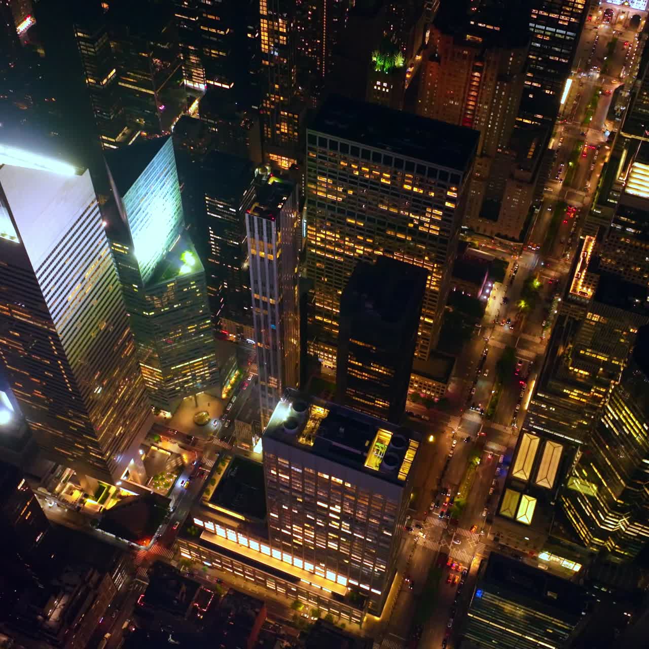 Majestic scenery of skyscrapers and multi-storied buildings of New York. Drone footage rising above the wonderful city at night time