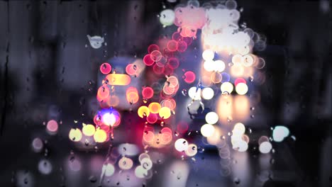 water droplet on window and bokeh from car light.