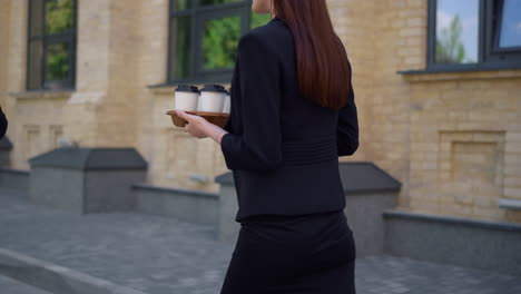 unknown people hurrying work on street. businesswoman going to work with coffee