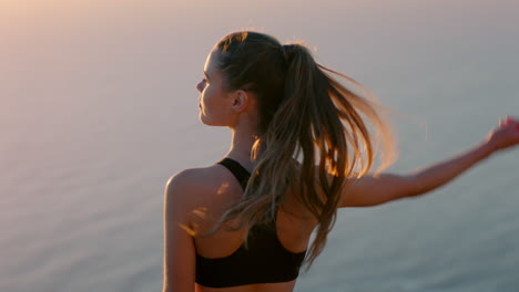 woman on mountain top looking at beautiful calm view of ocean at sunset girl standing on edge of cliff enjoying freedom contemplating journey to summit