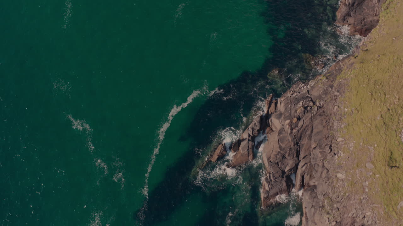 Coastal Landscape with Emerald Green Water and Rocky Cliffs