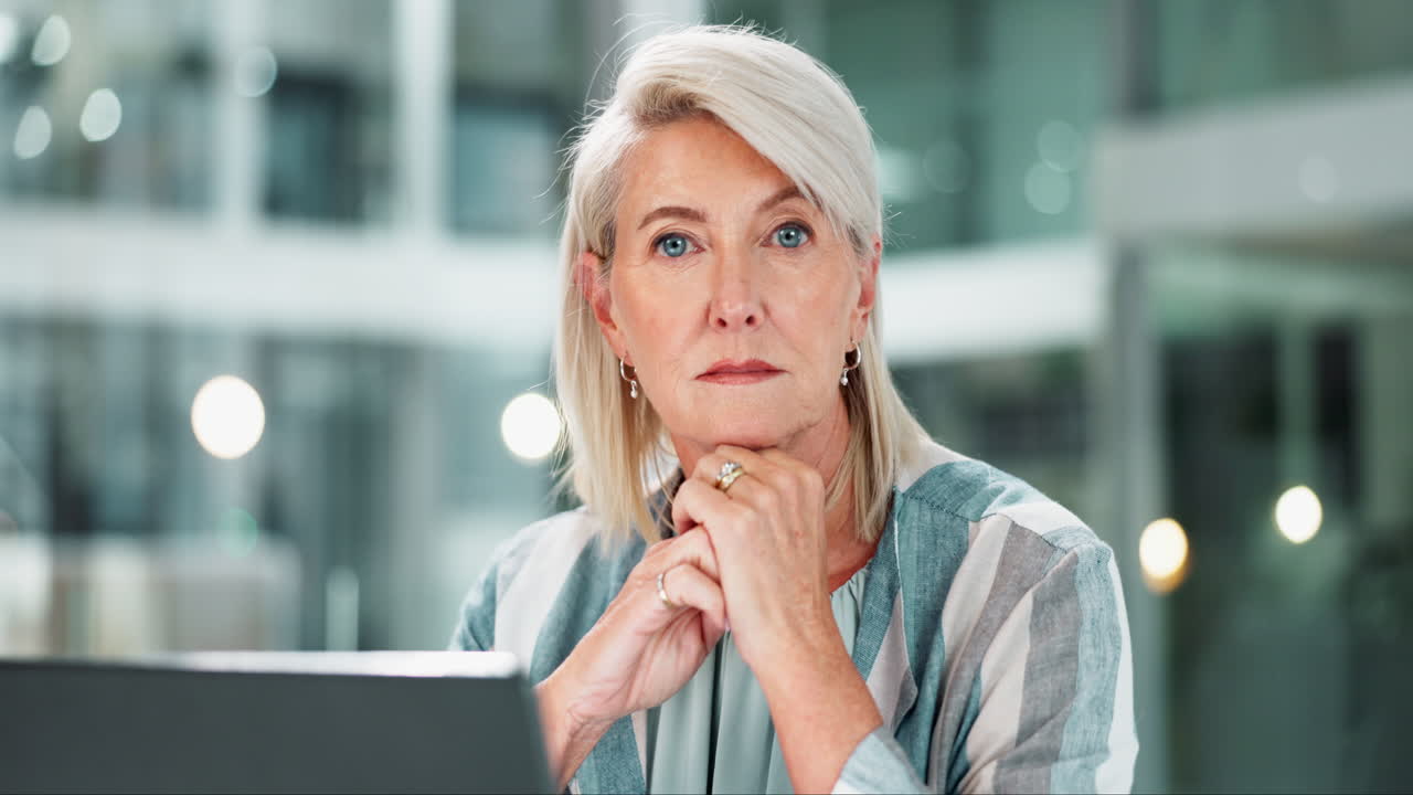 Portrait of a mature businesswoman with a laptop in the office
