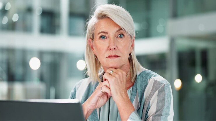 Portrait of a mature businesswoman with a laptop in the office