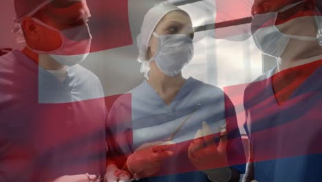 Animation-of-flag-of-switzerland-over-diverse-doctors-during-surgery