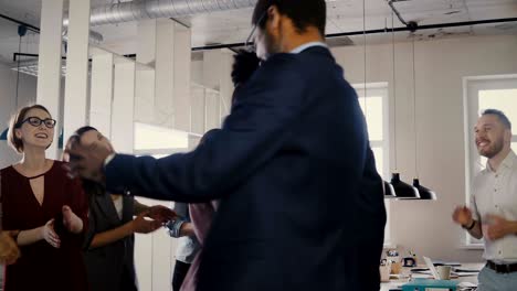 two african american colleagues dancing together at casual office party. diverse friends share fun time at work 4k