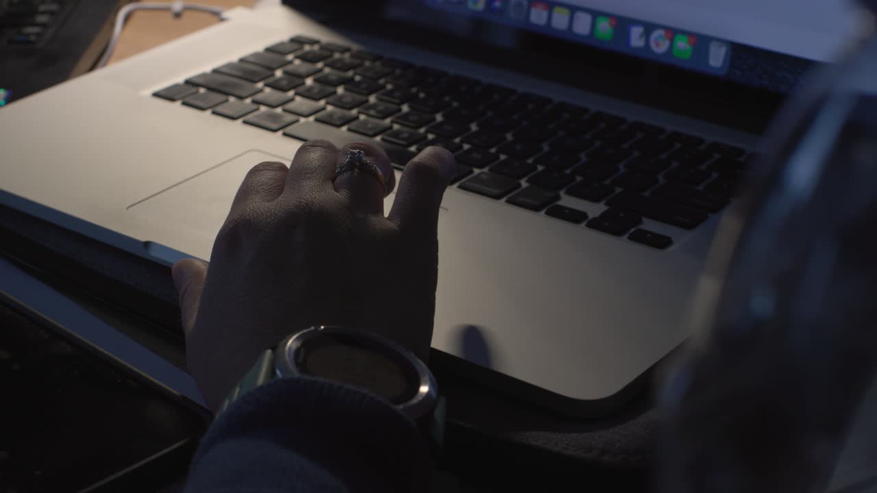 Female hand scrolling on laptop keyboard