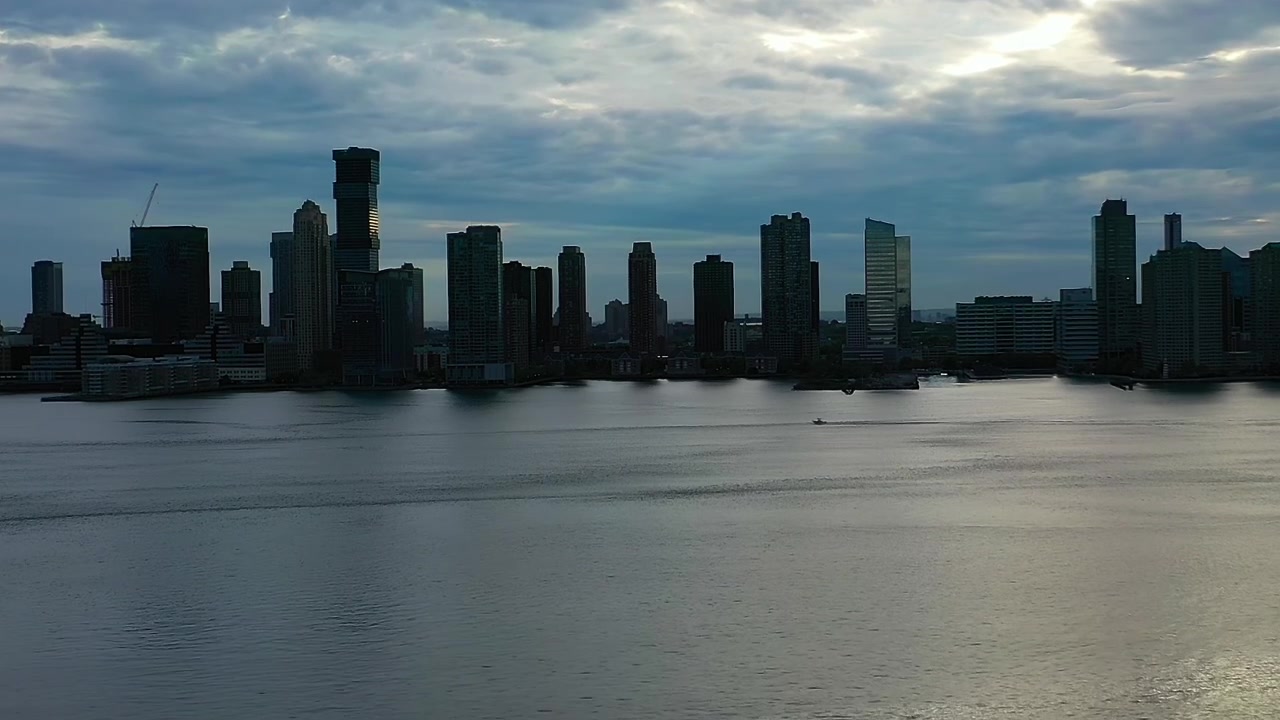 Skyline view of New York City across the water in cloudy weather