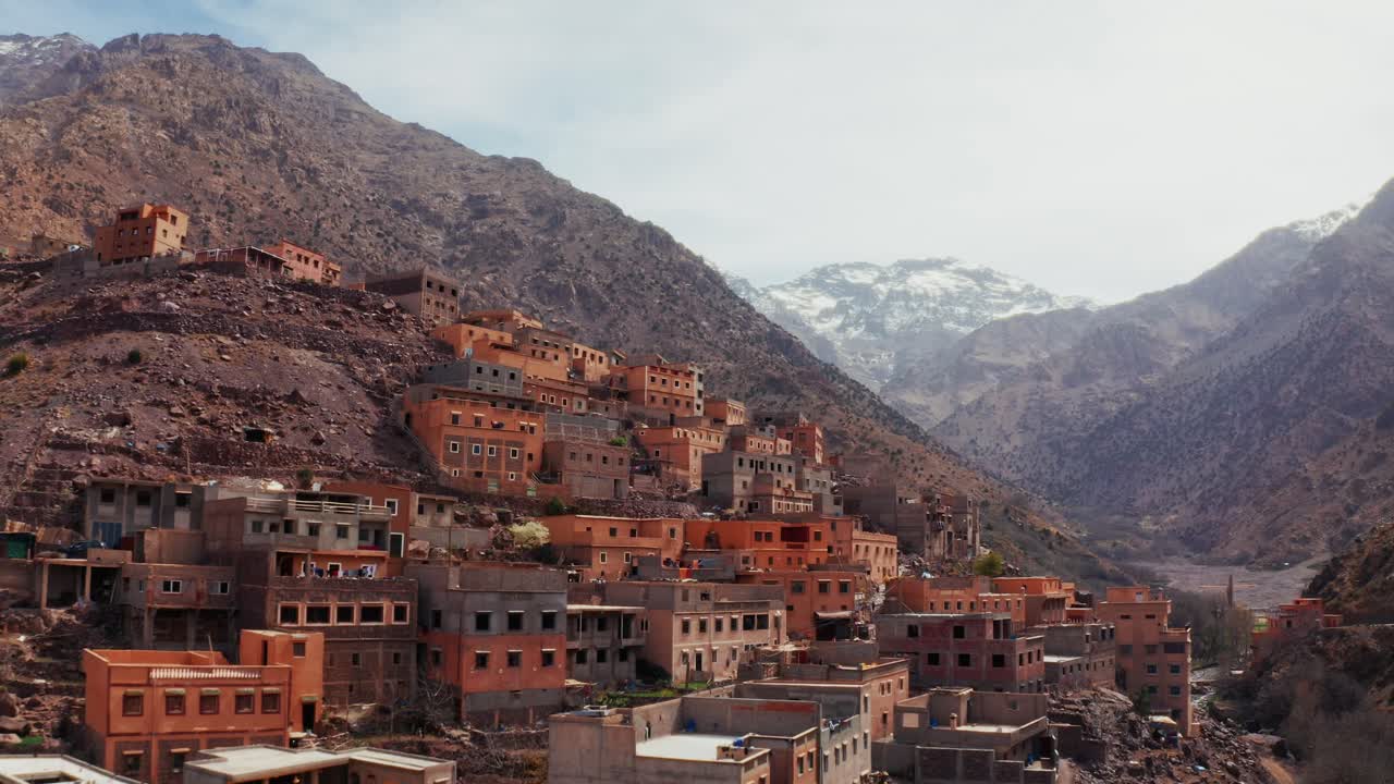 Aerial drone view of a remote rural Moroccan Village located on the High Atlas Mountains in Morocco.Camera moving back unveiling the landscape.