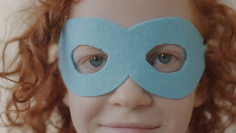 child wearing superhero mask