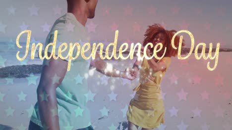 Animation-of-independence-day-text-with-american-flag-pattern-over-couple-in-love-on-beach