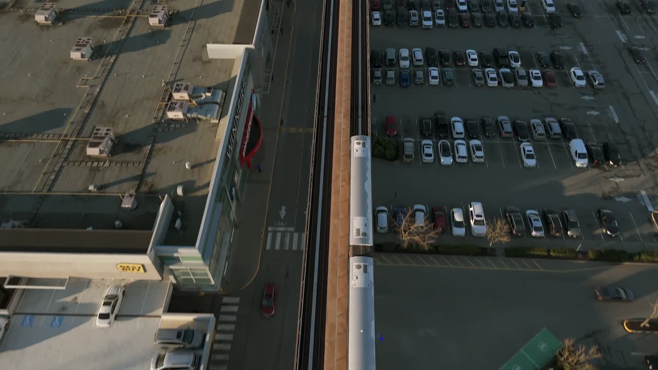 Subway Traveling Across King George Station In Surrey City Centre, British Columbia, Canada. Aerial Tracking Shot