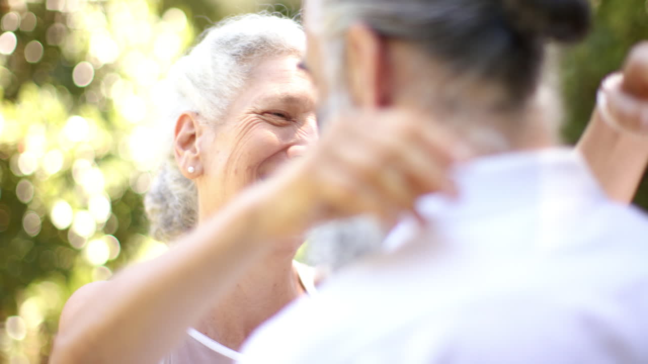 Hugging in park, senior couple sharing warm embrace at outdoor wedding