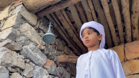 arab kid in arabian traditional house made with stone