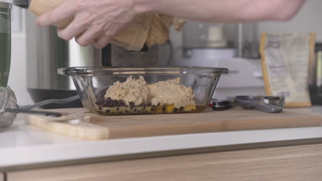 clip of white man pouring vegan cake batter in a loaf pan, in a modern kitchen setting