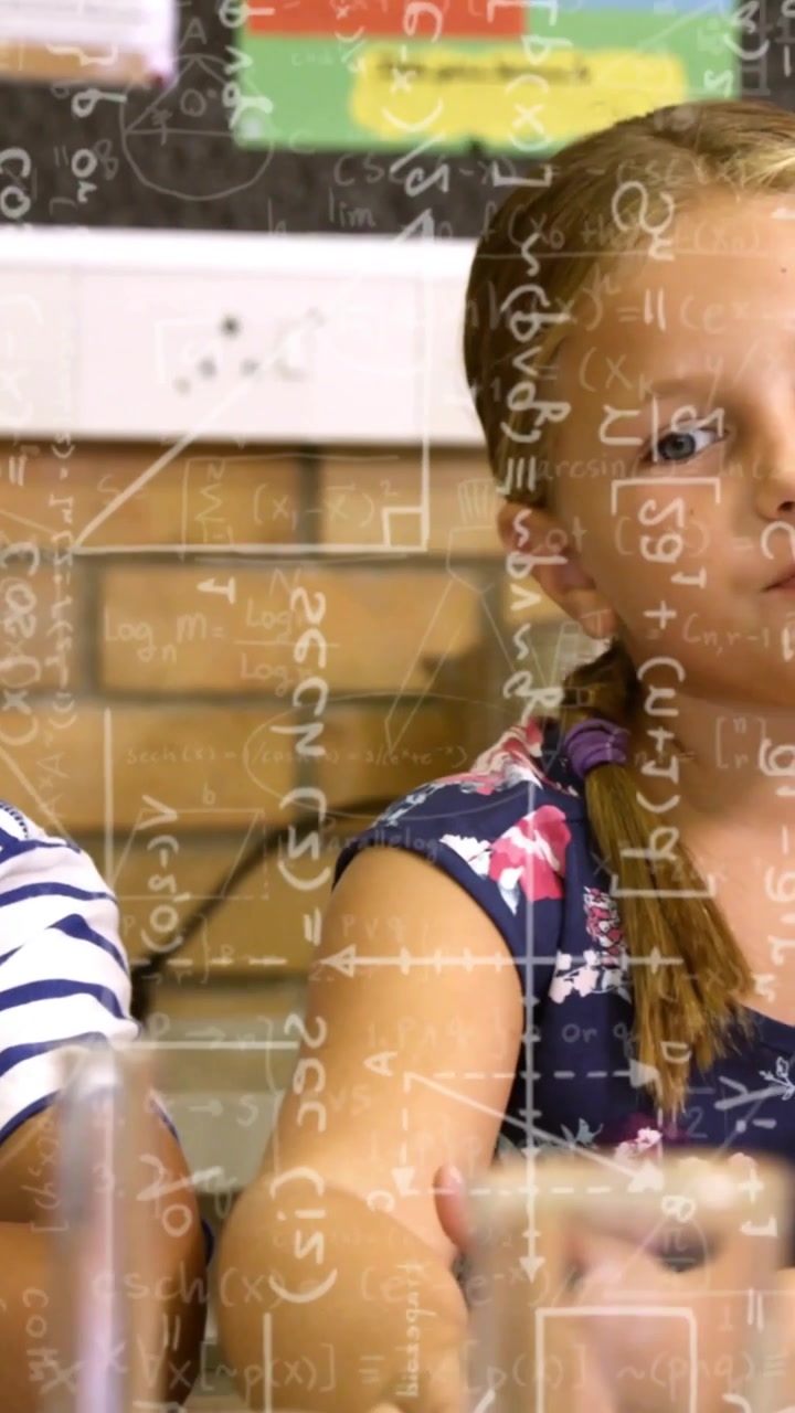 Vertical video: Boy in stripes pointing in response to question during STEM, formulas overlaying