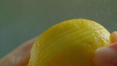 a person runs a zester over a lemon