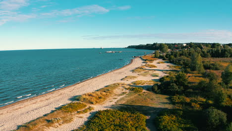 aerial view of drone flying above the beach to the baltic sea at the sunset