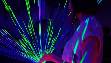 person interacting with vibrant laser light show