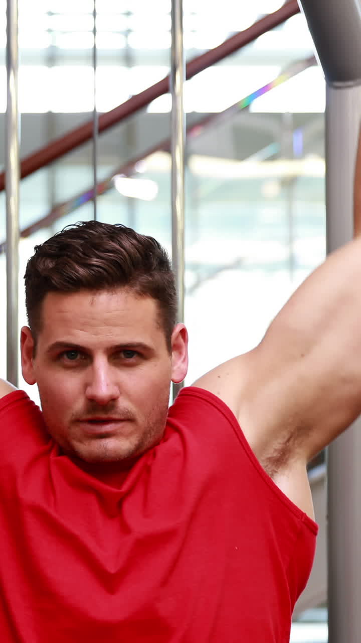 hombre en forma usando la máquina de pesas para sus brazos