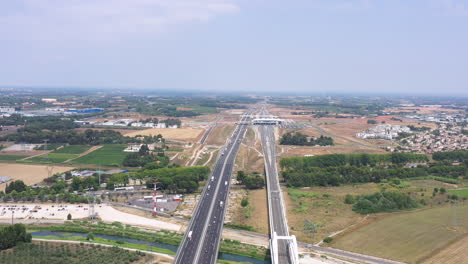 Highway-roads-with-train-station-in-background-Montpellier-aerial-shot-sunny-day