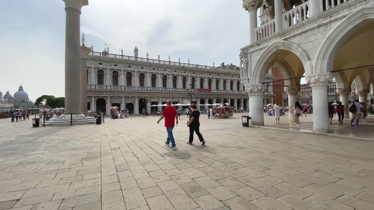 Walking In St. Mark's Square, Piazza San Marco. Tourists Sightseeing in Venice, Italy