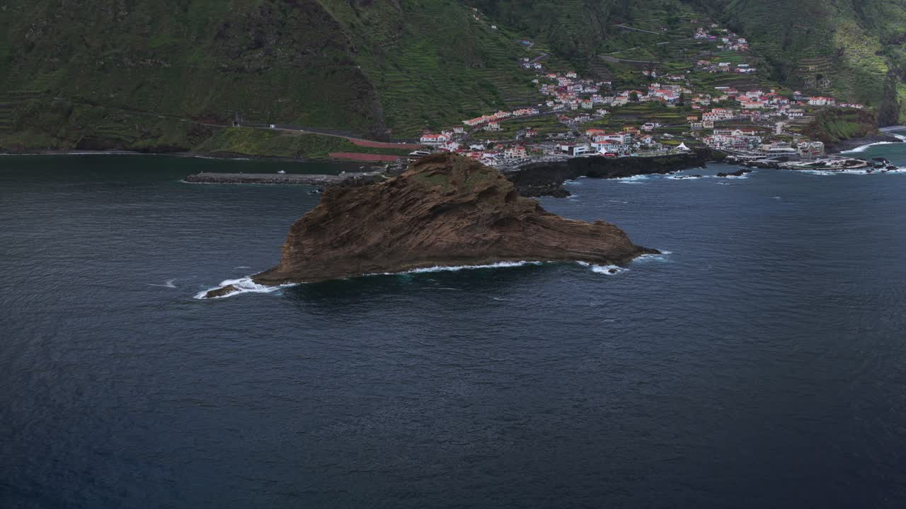 Aerial view of Ilheu Mole, a small islet located near Porto Moniz, Madeira, Portugal, with breaking waves. Aerial