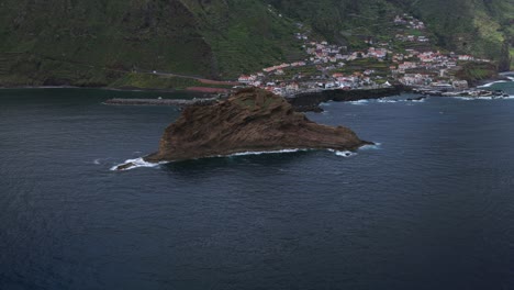 aerial view of ilheu mole, a small islet located near porto moniz, madeira, portugal, with breaking waves. aerial