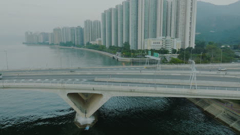 Panning-drone-over-a-busy-bridge-on-a-foggy-day