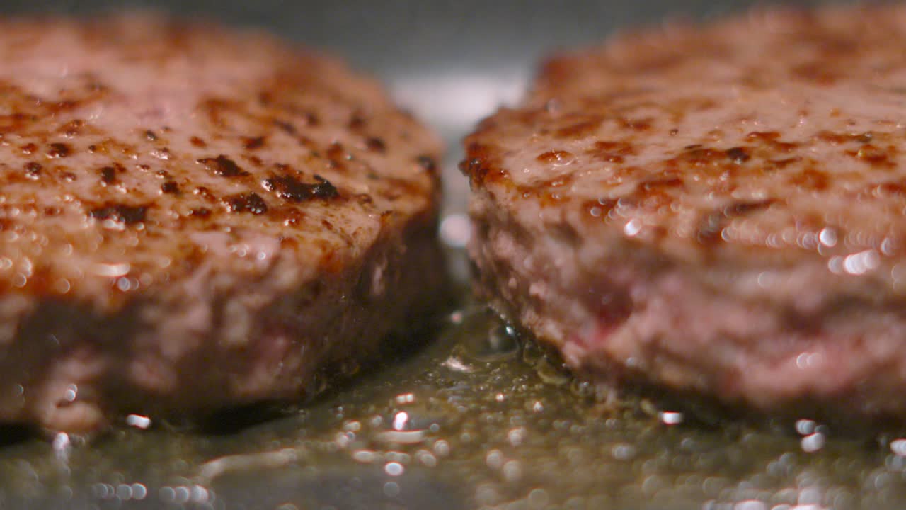 Detailed Ground Minced Meat Close Up Details of Beef Burgers with Bubbling Oil and Fat. Slow Motion Food Clip
