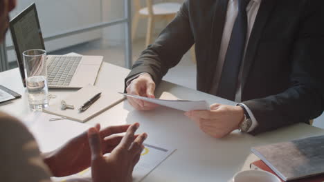 Two-Diverse-Businessmen-Signing-Contract-and-Shaking-Hands