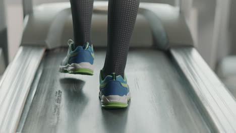 Closeup-legs-running-on-treadmill-in-fitness-gym.-Back-view-of-fitness-shoes