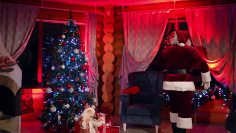 santa claus in house at night. santa claus in beautiful room during christmas night