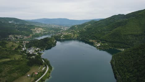 balkan city jajce on lake veliko plivsko in bosnia and herzegovina, aerial orbit