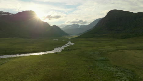 Rays-of-light-shine-on-beautiful-Jotunheimen-National-Park,-fields-of-heater,-peaceful-river