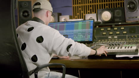 young caucasian man working at music recording studio