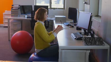 Young-caucasian-female-executive-meditating-at-desk-in-modern-office-4k