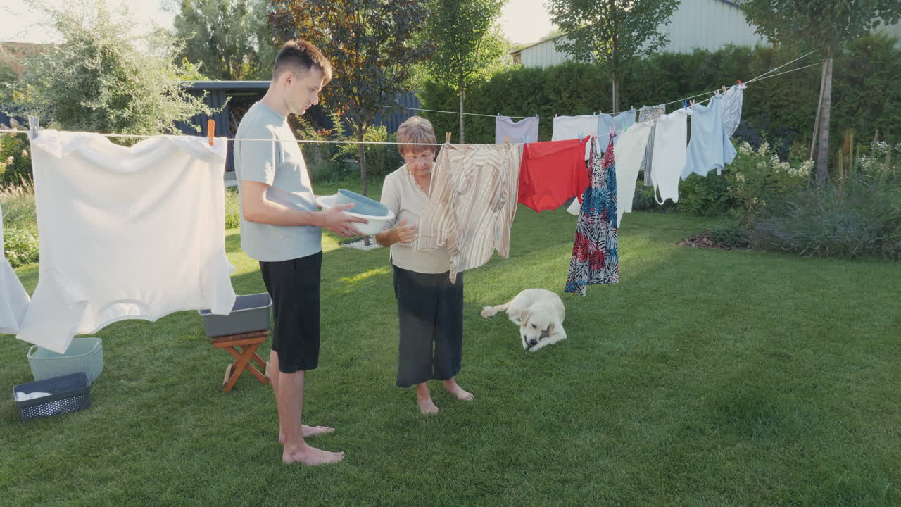 Grandparent and Grandson Doing Laundry in the Backyard