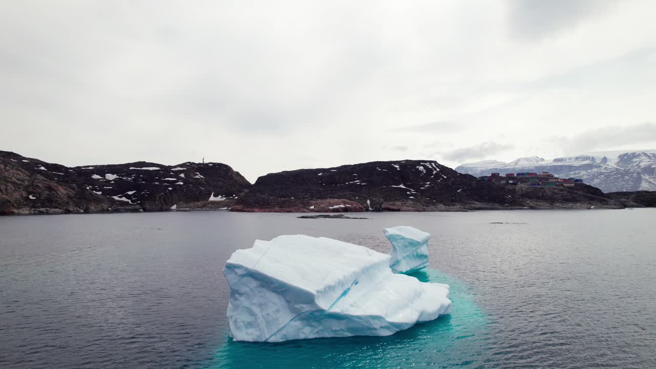 Drone Flyover Calving Iceberg in the Arctic, Uummannaq Greenland - Dolly Forward Shot