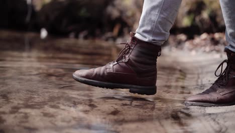 Man-splashing-shoes-into-a-cold-lake,-Furesø,-Denmark