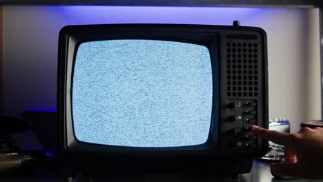 retro tv, vintage television in a nostalgic setup, a retro tv displays grain on screen, scary halloween night device good for chroma key and green screen.