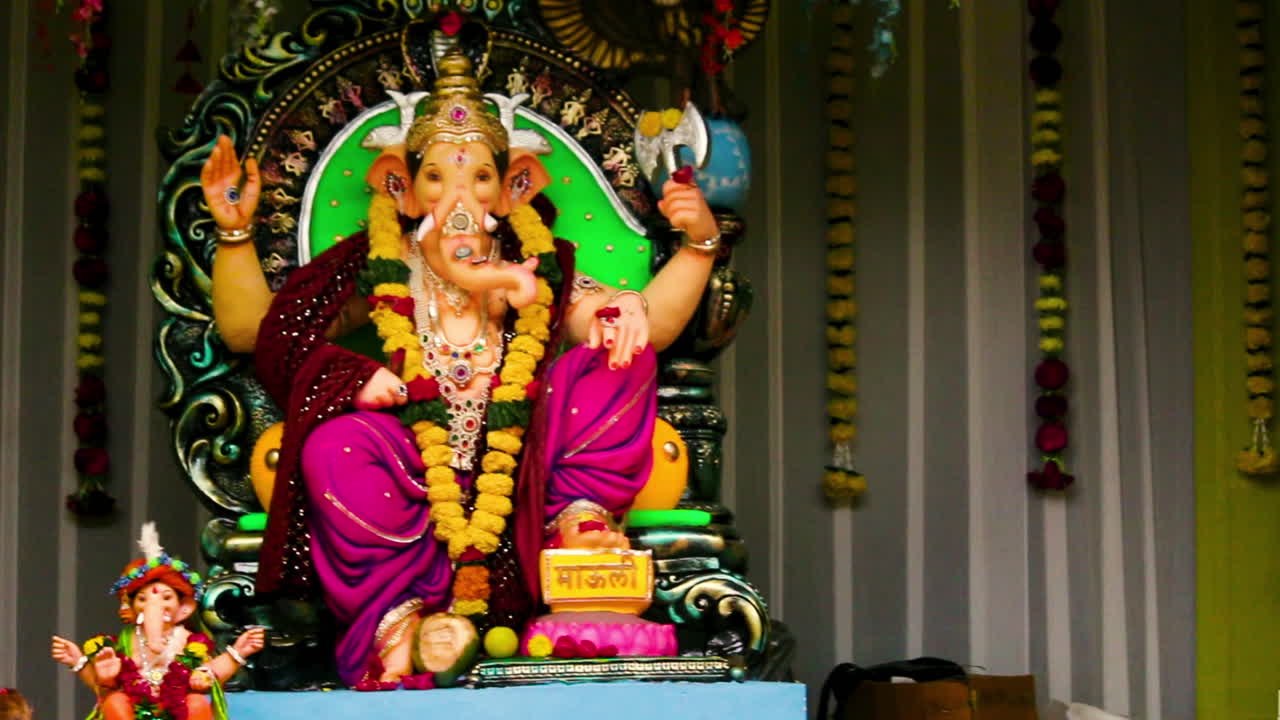 Lord Ganesha beautiful idol decorated with garlands and ornaments during Ganesh Chaturthi celebration. Perfect for cultural, spiritual and festive themes