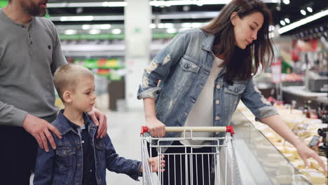 family shopping for cheese at the grocery store