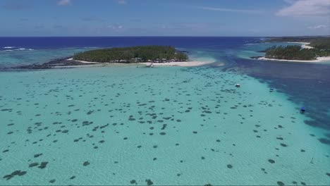 Crystal-clear-blue-waters-of-the-island-of-Republic-of-Mauritius-on-vacation-with-motor-boats-moving-around