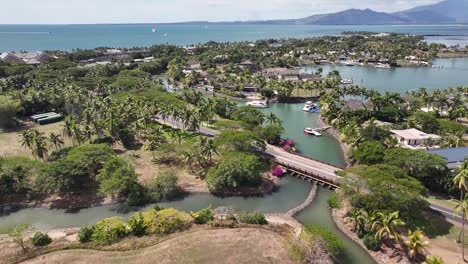 denarau island, viti levu, fiji - a vibrant tropical setting featuring a marina with boats, a coastal horizon, and mountains in the distance - aerial pullback shot