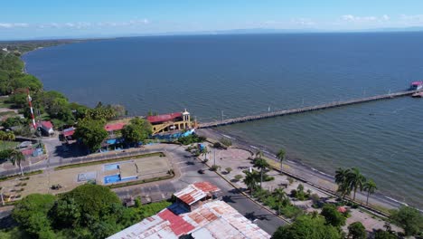 drone shot of lakefront of granada, nicaragua. port building and pier on sunny day