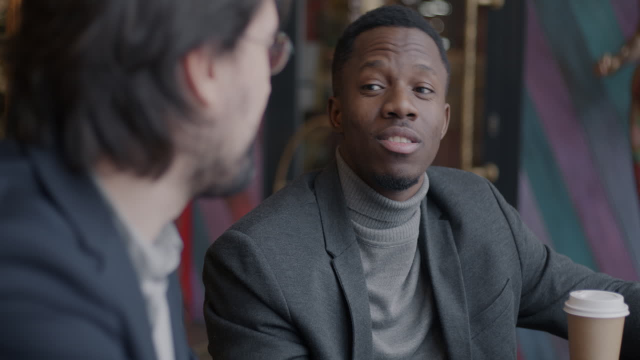 Two Men Discussing in a Cafe